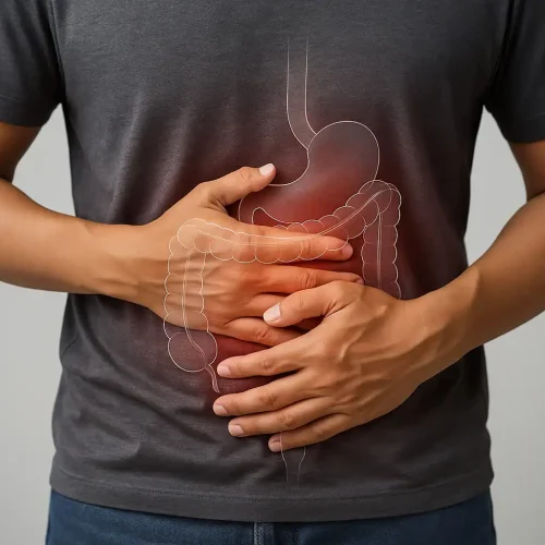 Man holding his stomach in pain, illustrating one of the 10 Signs of an Unhealthy Gut.